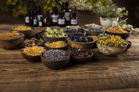 Homeopathy, herbal medicine on wooden tableの写真素材