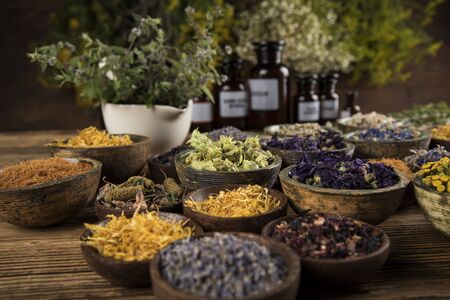 Homeopathy, herbal medicine on wooden tableの写真素材