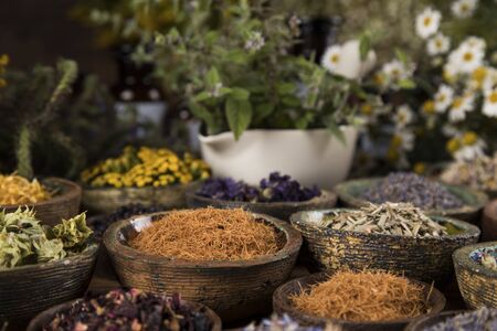 Homeopathy, herbal medicine on wooden tableの写真素材