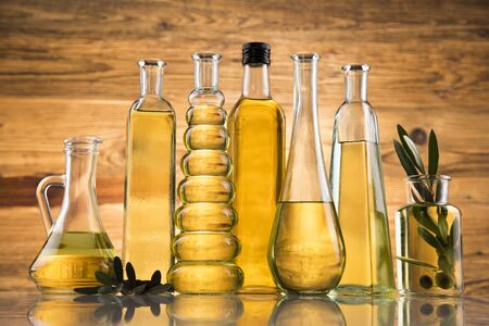 Bottles of olive oil, olive branch and Cooking oilsの写真素材