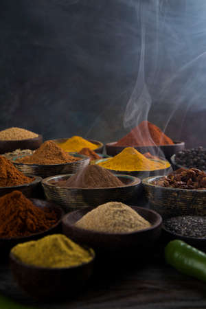 Assorted Spices and wooden bowl of smokeの写真素材