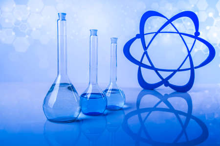 Atom, Laboratory beakers, microscope, blue backgroundの写真素材