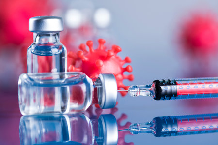 Vaccine vials and syringes on a blue backgroundの写真素材