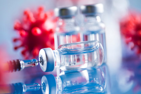 Coronavirus vaccine, bottle and syringe backgroundの写真素材