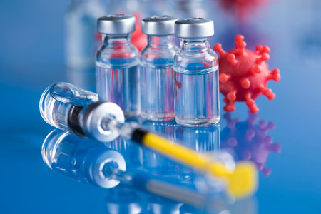 Coronavirus vaccine, bottle and syringe backgroundの写真素材