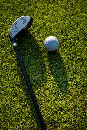 Golf player playing in a golf club on a beautiful sunset in the eveningの写真素材