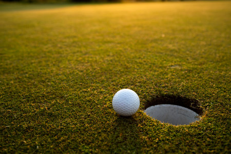 Close up of golf ball on green grass, Sport and lifestyleの写真素材