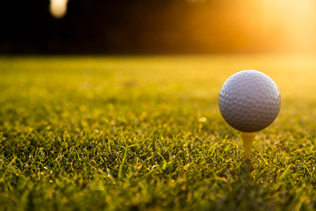Golf ball and clubs in golf fieldの写真素材