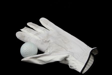 golf ball and golf glove on black backgroundの写真素材