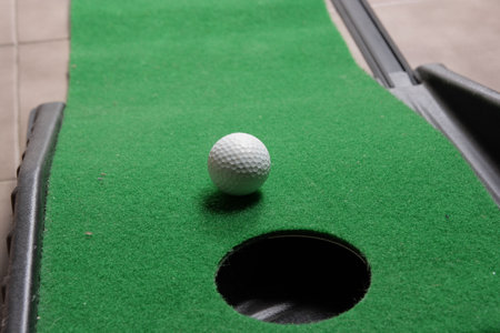 Office golf - golf ball near hole