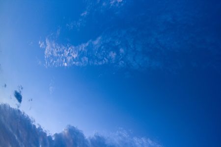 A dramatic blue sky with white cloudsの写真素材