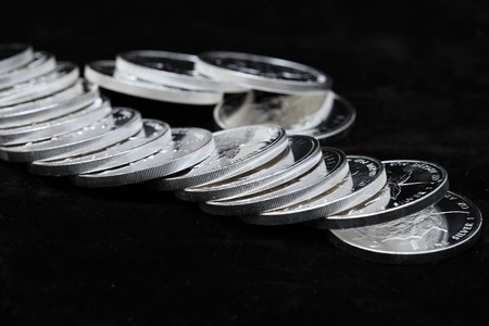 Silver coins isolated on a black backgroundの写真素材