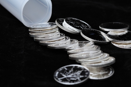 Silver coins isolated on a black backgroundの写真素材