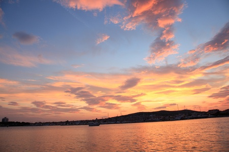 A dramatic sunset over the island and oceanの写真素材
