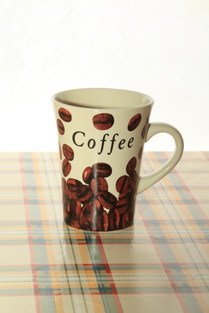 One cafe cup standing on a tableの写真素材