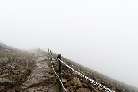 The way to the highest mountain in Krkonose National Park, Snezka. Foggy, windy and wet weather, the view of the ridge lost in cloud.の写真素材