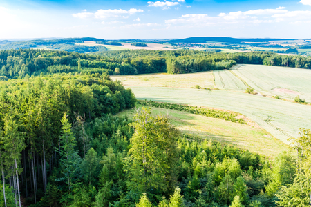 The view of Czech rural country from above from lookout tower on summer. Beautiful photo, forest, trees, fields, meadows, nice sky.の写真素材