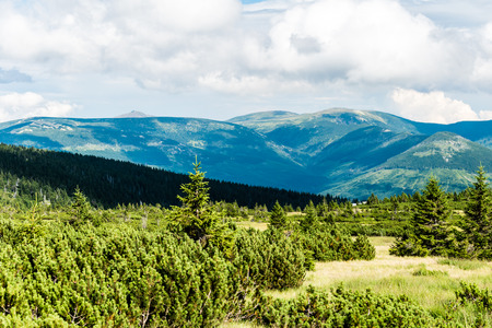 Beautiful mountain landscape and meadows on summer sunny day. Nice blue cloudy sky. The view from mountains in Krkonose National Park.の写真素材