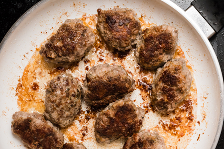 Meat balls of minced beef and pork on frying pan when cooking.の写真素材