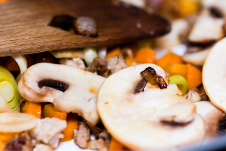 Roasted vegetables on cooking pan. Carrots, mushrooms, leeks, meat.の写真素材