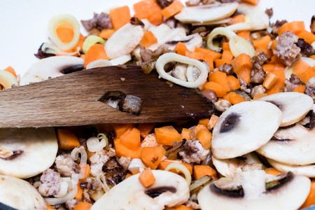 Roasted vegetables on cooking pan. Carrots, mushrooms, leeks, meat.の写真素材