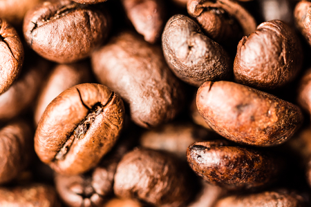 Close-up of many roasted coffee beans. Dark brown color makes it very tasty looking. Macro photography, very detailed.の写真素材
