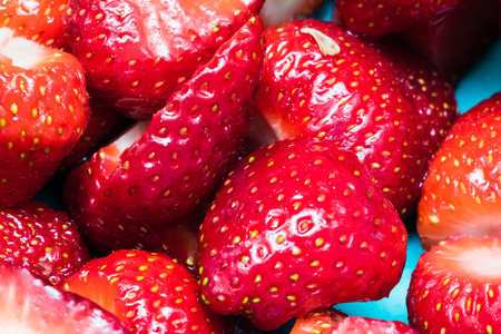 Detail of some sliced strawberries. Close-up shot, vibrant colors.の写真素材