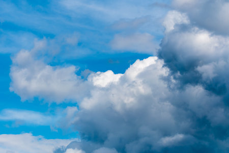 Nice blue sky with many small white clouds and two big clouds, beautiful background.