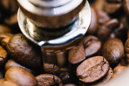 Coffee beans in a coffee grinder. Close-up, macro photography. Many details, beautiful colors.の写真素材