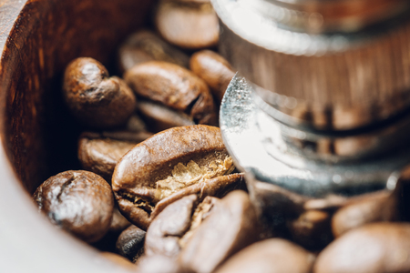 Coffee beans in a coffee grinder. Close-up, macro photography. Many details, beautiful colors.の写真素材