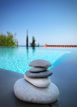 Stack of zen stones on the background of a swimming pool.の写真素材