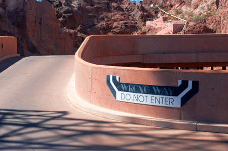 Wrong way sign (do not enter) on parking in bare desert mountains. The picture is taken in Hoover Dam. Theme for transportation.のeditorial素材