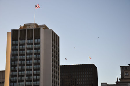 Dominating skyscraper with american flag. The picture is taken in the San Diego Downtown.