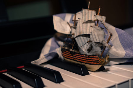 The model of the medieval Galeona floating through the black&white keyboard. The handkerchief shows...