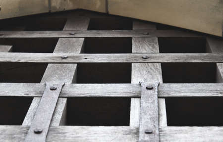 Detail of the wooden castle gate in arched shape in the evening.の写真素材