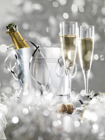 Two champagne glasses, a cooler with cork and silver decoration, stylish tintedの写真素材