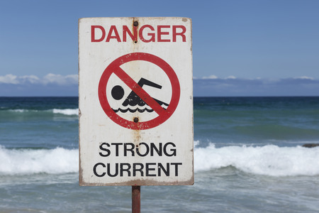 Dangerous currents sign at Bondi Beach in Sydney, Australia. On a sunny dayの写真素材