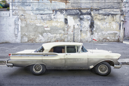A grey and green American car still running on the streets of Cuba.の写真素材