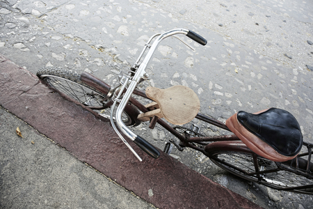Bycicle parking on the sidewalk background grungy old street, feeling vintageの写真素材