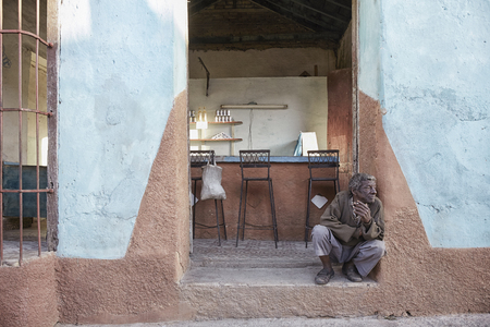 old poor man in front of a bar,trindad cubaのeditorial素材