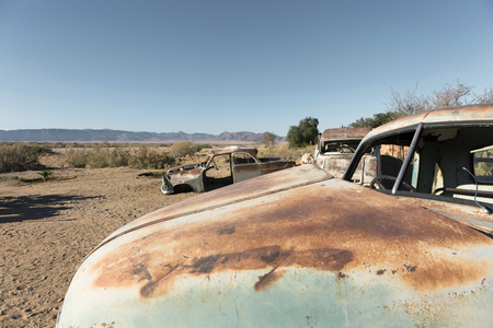 Old cars, all rusted and abandoned in the middle of the southern desert of Namibiaの写真素材
