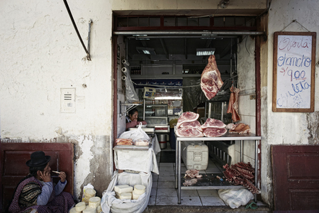 female butcher cutting meat in Lima street market. Peruのeditorial素材