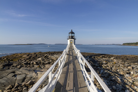Lighthouse at Early Sunset Looks Out Over Lake with Beautiful Sky, USAの写真素材