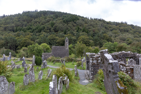 Ancient Celtic gravesite with unmarked gravestones and old rundown church in irelandの写真素材
