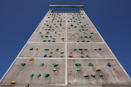 Background of empty climbing wall in a climbing center adventure park against blue skyの写真素材