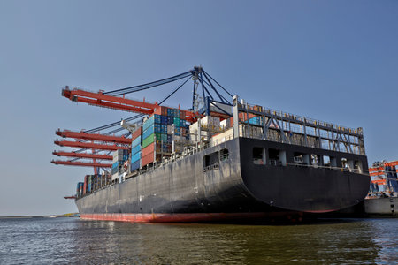port of Rotterdam. The Netherlands. Large harbor cranes loading container ships in the port of...