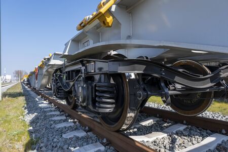 Cargo trains close-up. Aerial view of colorful freight trains on the railway station. Wagons with goods on railroad. Heavy industry. Industrial conceptual scene with trains. Top view from flying droneの写真素材