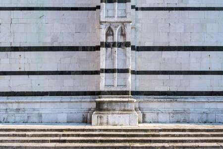 Stone wall from marble. Detail of an old church in italyの写真素材