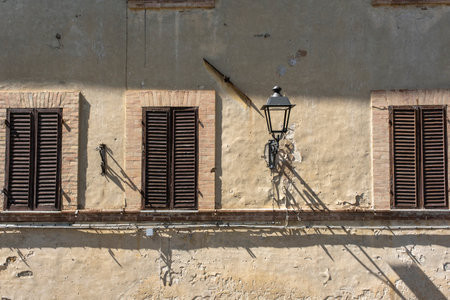 Windows in a old stone center in a town in umbria italyの写真素材