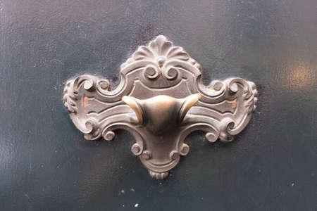 Antique door knocker on wooden doorの写真素材